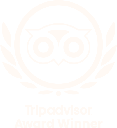 A black and white Tripadvisor Award Winner badge featuring an owl icon surrounded by a laurel wreath.